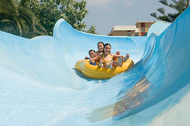 friends on a water slide - inflatable slide sliding child - fotografias e filmes do acervo