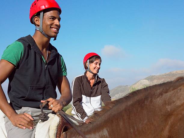 two teenagers riding horses - adventure african ethnicity rural scene day - fotografias e filmes do acervo