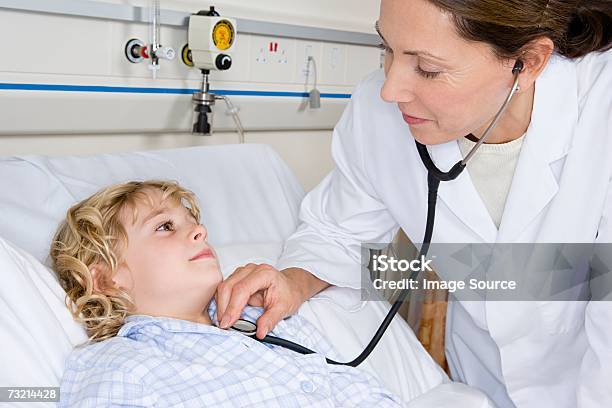 Child And Doctor With Stethoscope Stock Photo - Download Image Now - Bed - Furniture, Child, Hospital