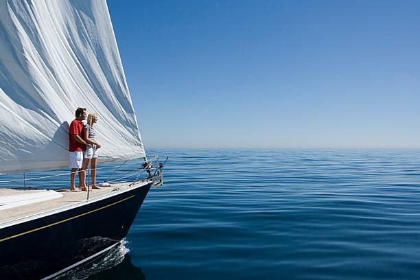 Couple standing on a ships bow  sailing couple stock pictures, royalty-free photos & images