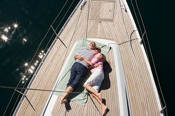 Couple asleep on deck of sailboat  sailing couple stock pictures, royalty-free photos & images