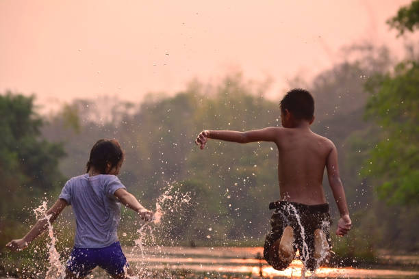 istock Children Playing In River Against Sky At Dusk 732738197