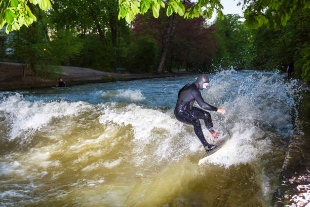istock Side View Of Person Surfboarding In River 733523055