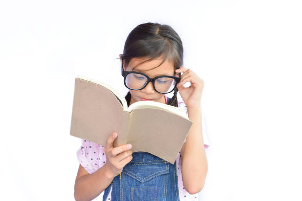 The little boy is reading carefully
