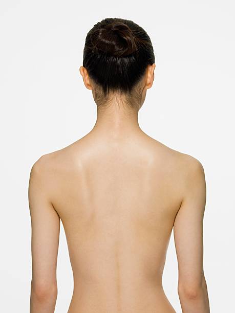 Rear view of a young woman  naked stock pictures, royalty-free photos & images