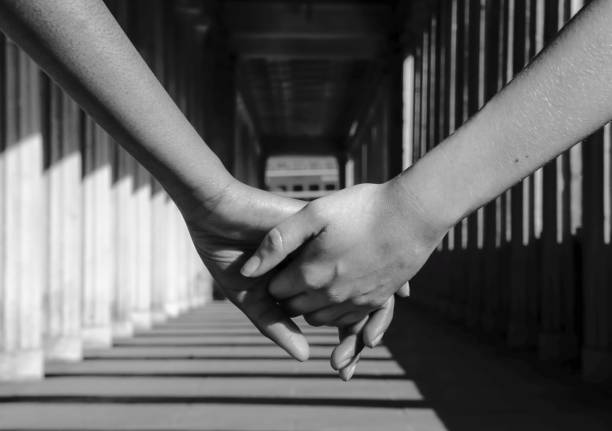 istock Cropped Image Of Friends Holding Hands At Corridor 735962373
