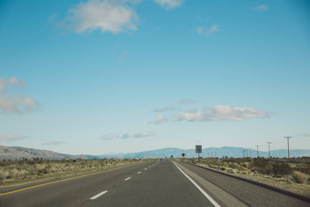 istock Road By Landscape Against Blue Sky 736020063