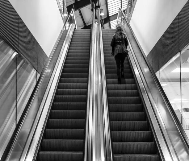 istock Low Angle View Of Woman On Escalator 736518737
