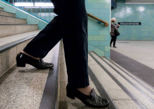 istock Low Section Of Woman Moving Down On Steps At Subway Station 736839017