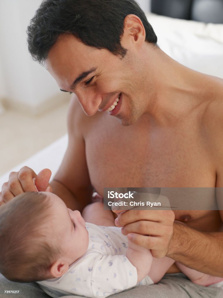 Father playing with baby daughter  2-5 Months Stock Photo