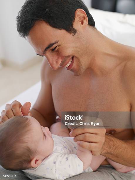 Father Playing With Baby Daughter Stock Photo - Download Image Now - 2-5 Months, 30-34 Years, 30-39 Years