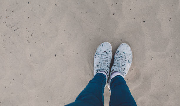 istock Low Section Of Woman Standing On Sand At Dessert 740626577