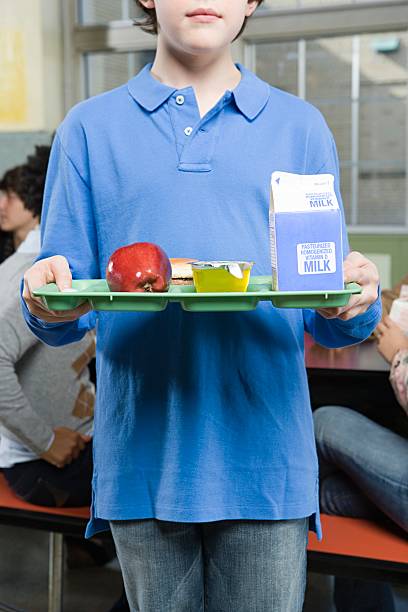 Boy with lunch tray  milk carton stock pictures, royalty-free photos & images