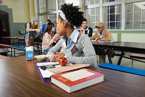 Girl by herself in cafeteria  school exclusion stock pictures, royalty-free photos & images