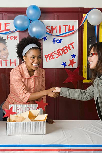 girls shaking hands at student election - voting election politics little girls zdjęcia i obrazy z banku zdjęć