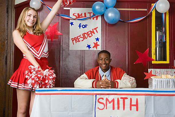 cheerleader and boy running for president - voting election politics little girls zdjęcia i obrazy z banku zdjęć