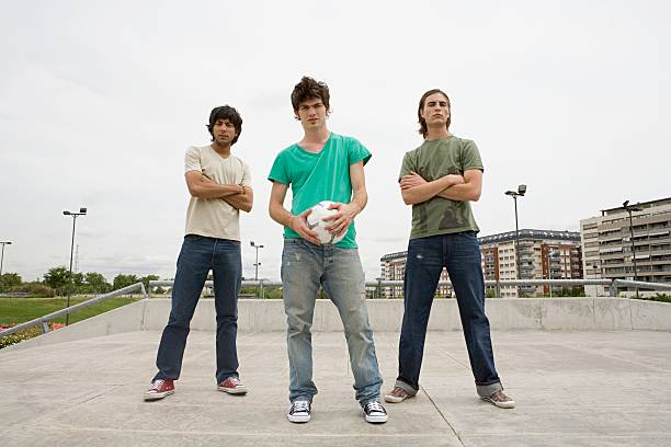 young men with football - three boys ストックフォトと画像