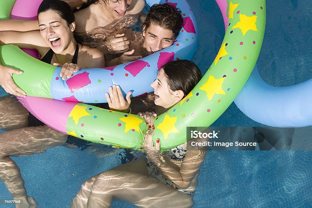 Friends playing in pool  Swimming Pool Stock Photo