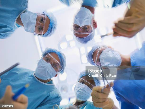 Low Level View Of Surgical Team Operating Stock Photo - Download Image Now - Doctor, Surgery, Operating Room