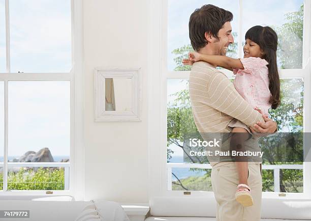 Side Profile Of Father And Daughter Embracing Stock Photo - Download Image Now - Father, Girls, 25-29 Years