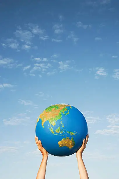 Photo of Hands holding globe outdoors