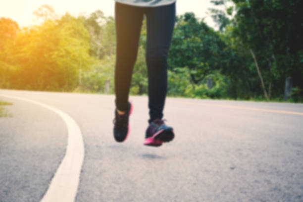 istock Low Section Of Woman Jogging On Road 742262359