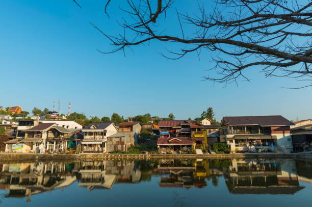istock Reflection Of Houses And Trees Against Clear Sky 742334757