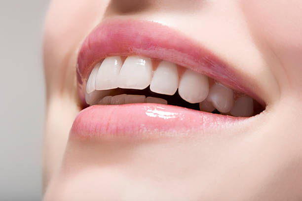 woman wearing gloss de labios - dientes humanos fotografías e imágenes de stock
