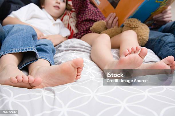 Family On Bed Stock Photo - Download Image Now - Girls, Picture Book, Storytelling