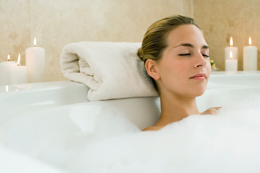 Young happy woman taking bath at home, treat yourself