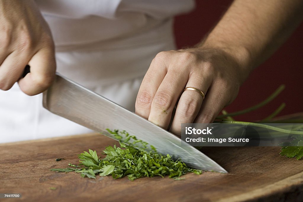 Chef chopping parsley  Kitchen Knife Stock Photo
