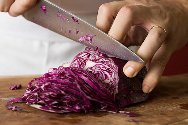 Person chopping red cabbage  carving set stock pictures, royalty-free photos & images