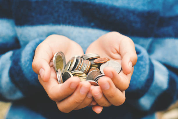 istock Cropped Image Of Person Holding Coins 746099785