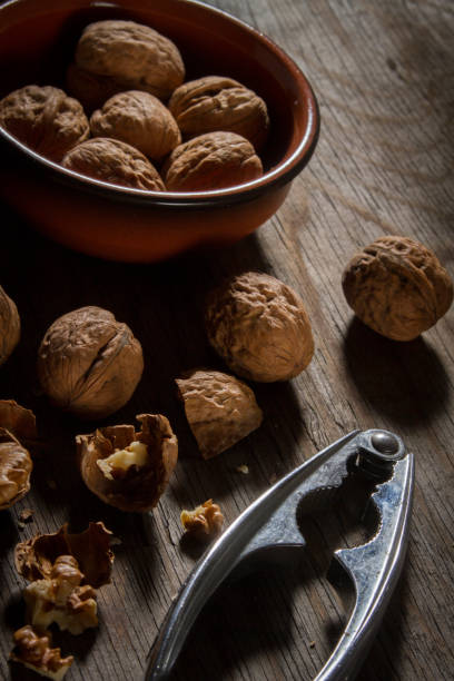 istock Close-Up Of Walnuts And Nutcracker On Wooden Table 746100385