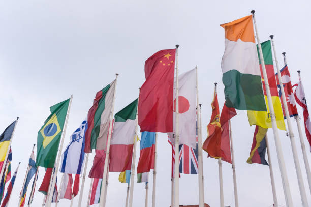 istock Low Angle View Of National Flags Waving Against Sky 746119227