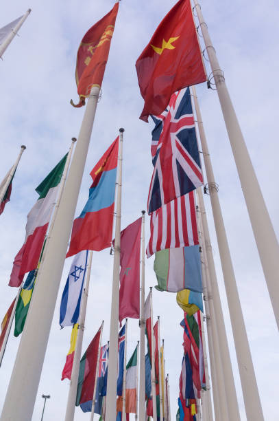 istock Low Angle View Of National Flags Waving Against Sky 746119965