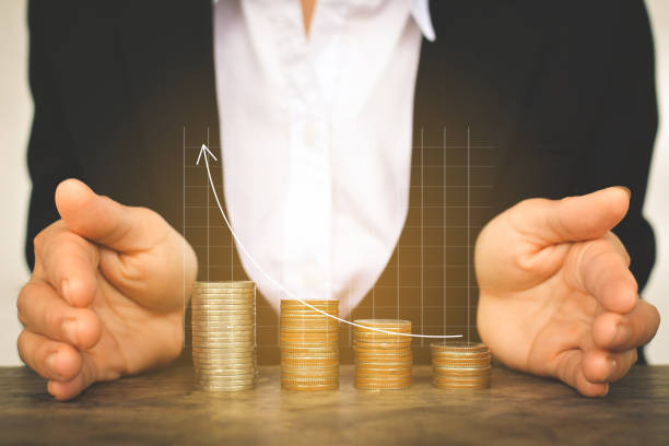 istock Digital Composite Image Of Businessman Covering Stacked Coins With Line Graph 746125645