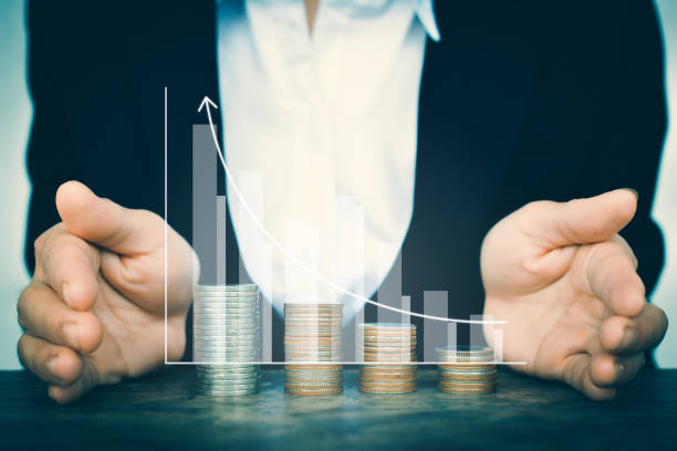 istock Digital Composite Image Of Businessman Cupping Hands Around Coins Stack And Bar Graph 748585217