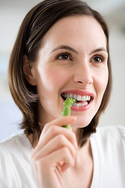 Woman eating asparagus  eating asparagus stock pictures, royalty-free photos & images