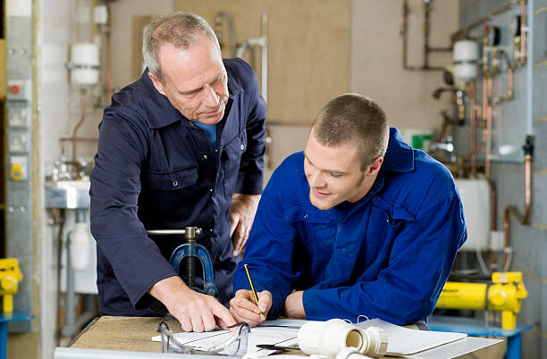 Plumber and apprentice  guide occupation stock pictures, royalty-free photos & images