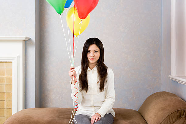 Young woman with balloons  chaise longue woman stock pictures, royalty-free photos & images