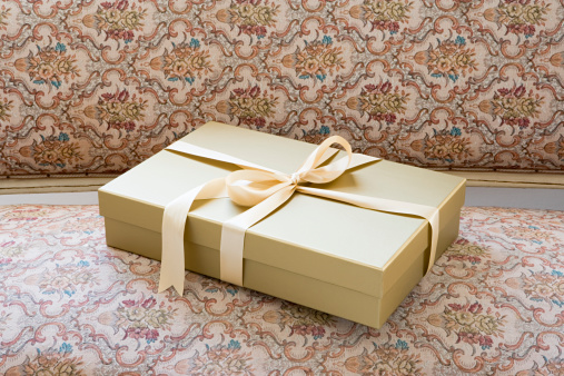 Three elegant gift boxes with ribbon against blue illumination background.