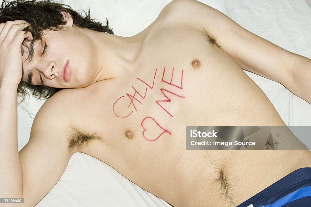 Teenage Boy With Writing On Chest Stock Photo - Download Image Now - The  Morning After, Bed - Furniture, Bedroom - iStock