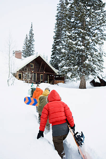 Snowboarders returning to chalet  snowboarding snowboard women snow stock pictures, royalty-free photos & images