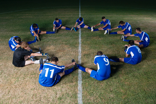 Rugby, training and a sports team in a huddle on a field for a game, competition or fitness practice. Teamwork, exercise and workout with a group of athlete men in a circle together for preparation