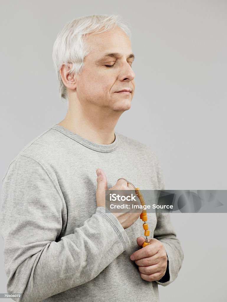 Mature man praying  Adults Only Stock Photo