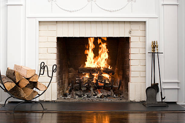 fireplace with fire burning - fireplace stockfoto's en -beelden
