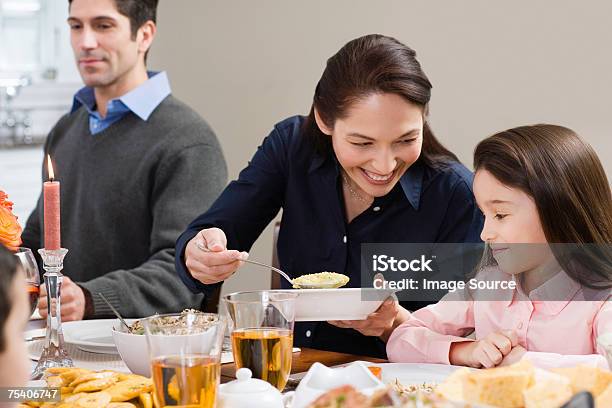 Mother Serving Food To Daughter Stock Photo - Download Image Now - Candle, Dinner, 30-39 Years