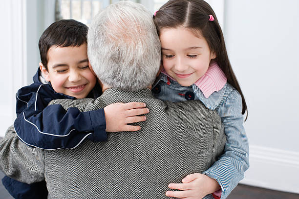 Brother and sister hugging grandfather  hello stock pictures, royalty-free photos & images