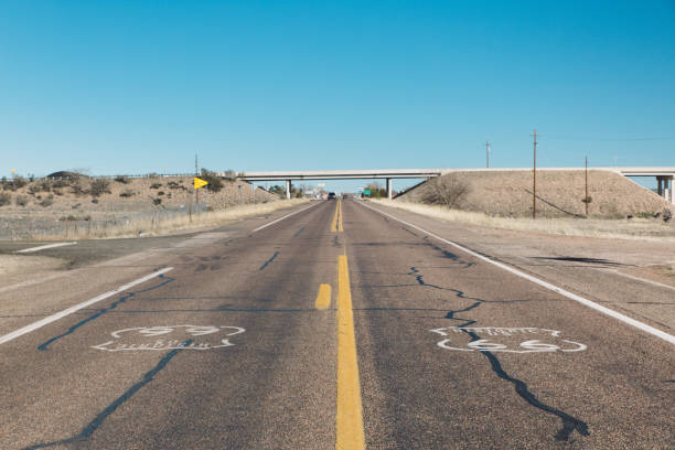 istock Empty Country Road Passing Through Arid Landscape Against Clear Sky 755743389